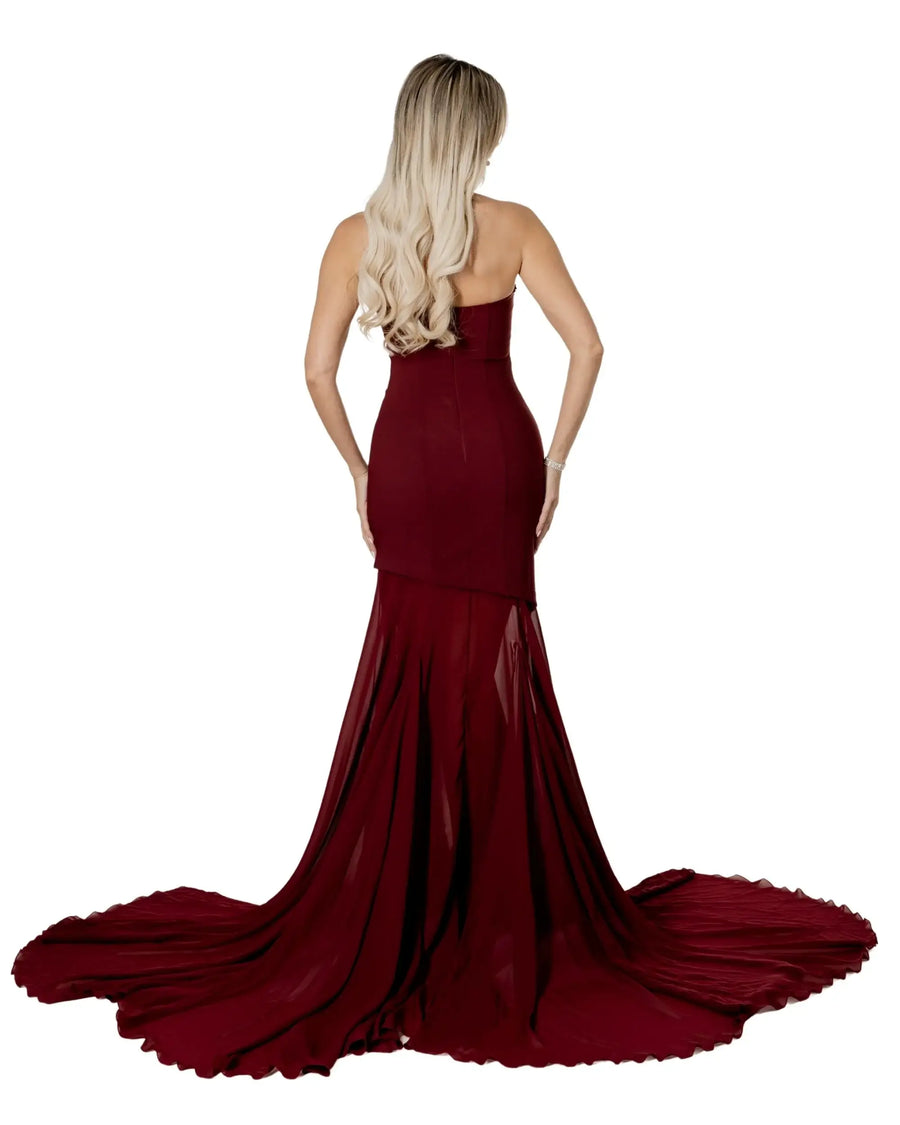 Back view of a model wearing the Black Swan Statement dress with a dramatic train.